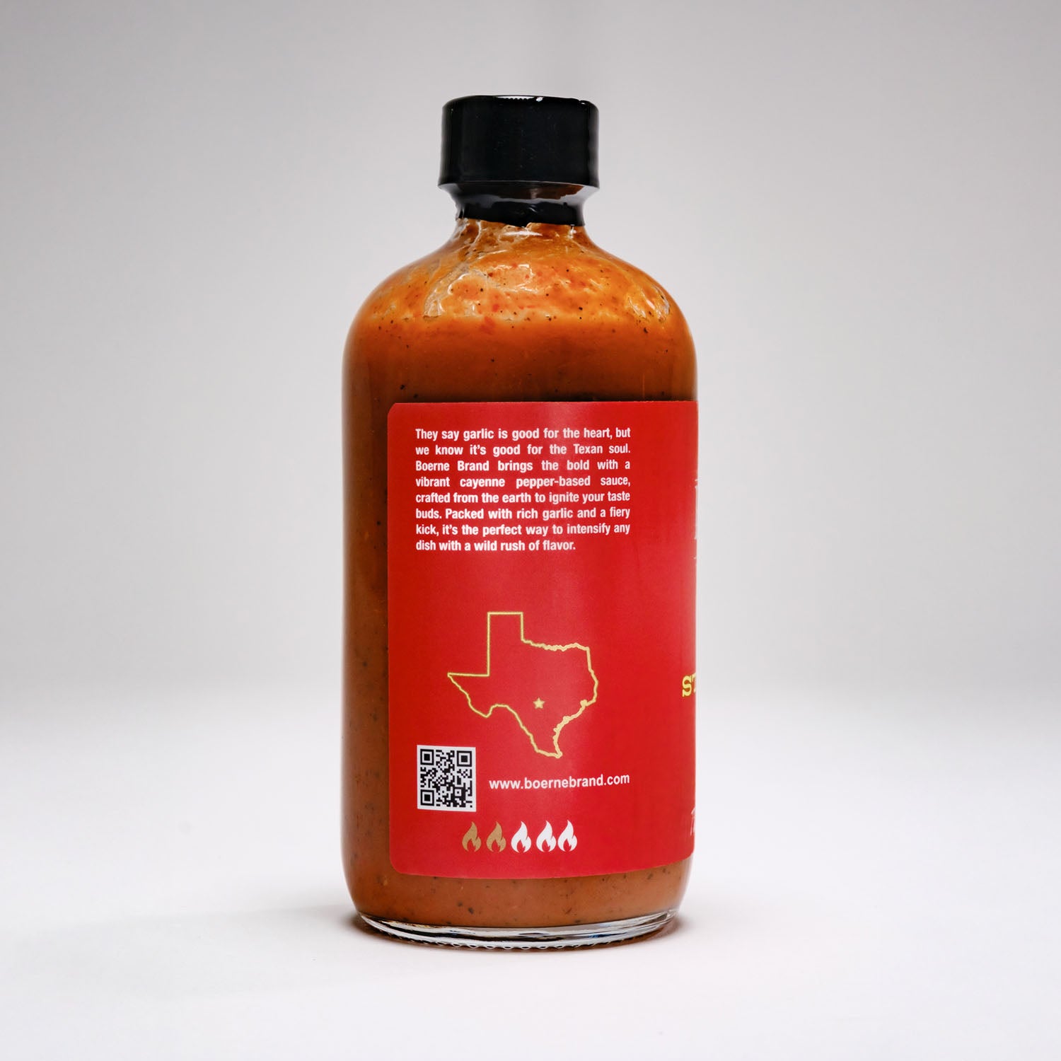 Back label view of Boerne Brand Garlic Stampede Texas-style hot sauce bottle