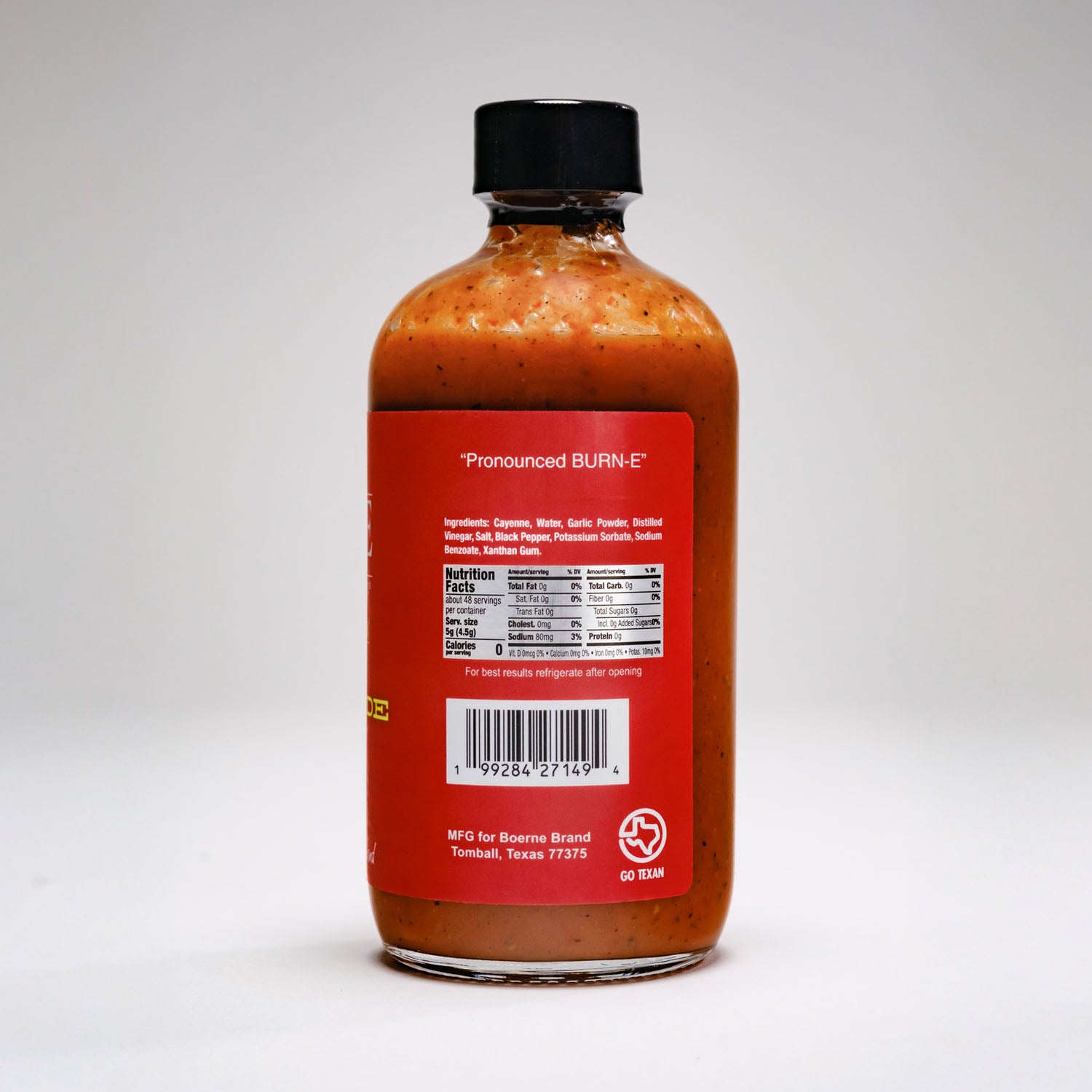 Side view of Boerne Brand Garlic Stampede Texas-style hot sauce bottle