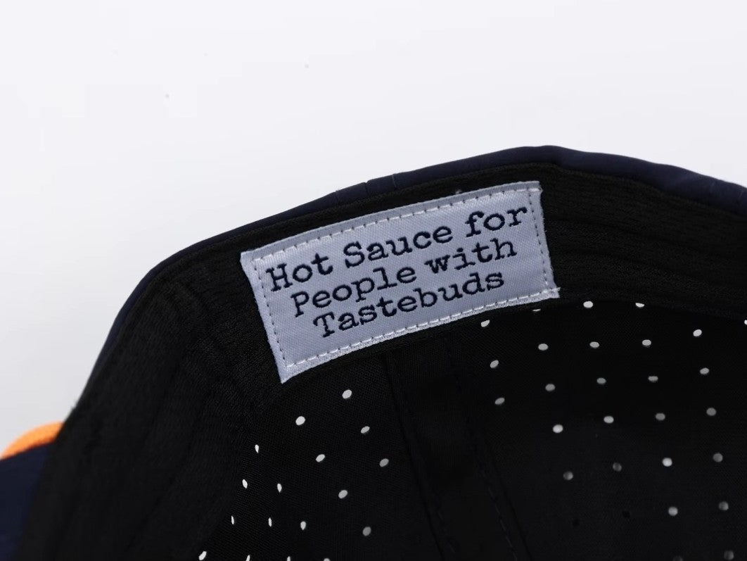 Close-up of Boerne Brand hat interior tag reading “Hot Sauce for People with Tastebuds